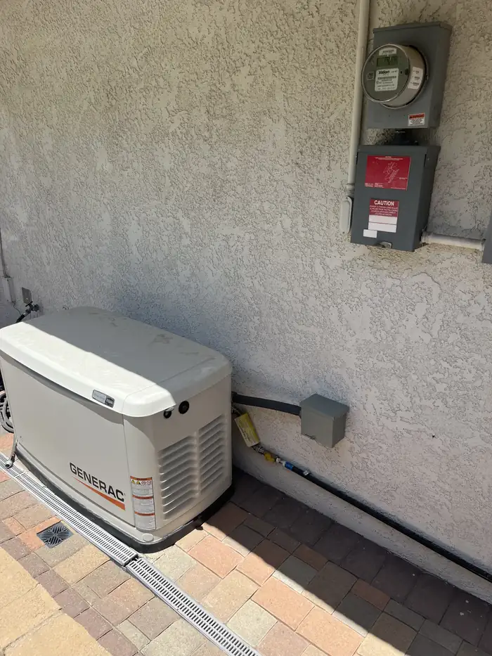 Generac standby generator set on pavers beside the meter and service disconnect at a home