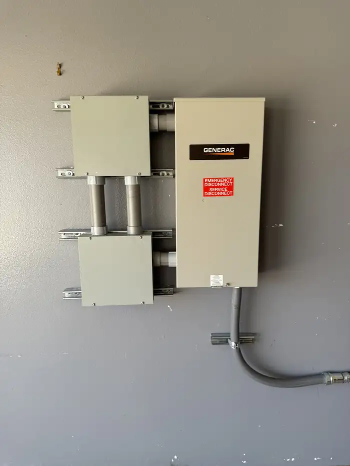 Close view of a Generac transfer switch with the emergency service disconnect label